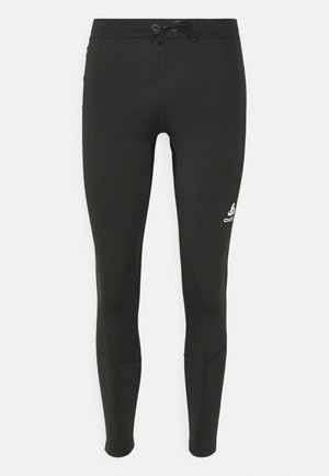 Black leggings made from stretchy fabric, featuring a drawstring waist and a white logo on the lower leg. Smooth texture, fitted design.