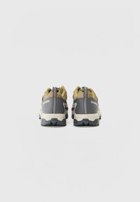 Trail running shoes with a gray and olive upper, textured mesh, sturdy heel counter, and contrasting white midsole and black outsole.