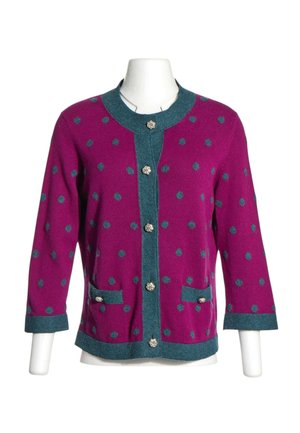 Cardigan violet à pois bleus, bordure bleue, boutons argentés, deux poches avant et manches trois-quarts sur un mannequin blanc.