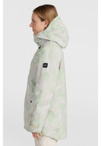 Light green patterned jacket with a hood, front zipper, snap pockets, and adjustable cuffs. Features a subtle camo design and branded patch.