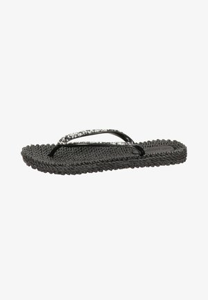 Chanclas negras con suela de textil trenzado, tiras brillantes negras con un acento brillante. Su diseño plano ofrece comodidad casual para el uso veraniego.