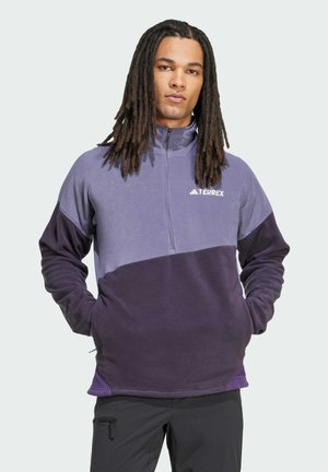 Terrex fleece pullover features a color-block design in light and dark purple, zipper neck, long sleeves, and soft texture. Adjustable hem detail.
