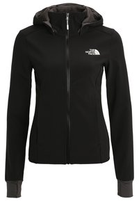 Veste noire The North Face pour femmes avec capuche, fermeture éclair intégrale à l'avant et logo sur le côté gauche de la poitrine, avec poignets munis de trous pour le pouce.