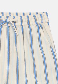 Lette, kremfargede shorts i stoff med blå og svarte vertikale striper. Har elastisk midjebånd med snor og sidelommer.