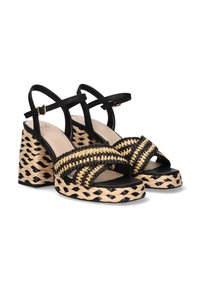 Sandalias de plataforma negras y beige con textura trenzada, correas anchas y tacones en bloque con diseño trenzado. Correa ajustable en el tobillo.