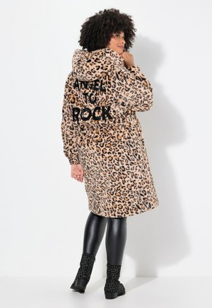 Leopard-print coat with a hood, features "ANGEL TO ROCK" in black text on the back, paired with shiny black leggings and embellished black boots.
