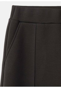 Donkerbruine rok met een brede tailleband, zijzakken en een schoon, minimalistisch ontwerp met een gladde textuur en subtiele stikdetails.