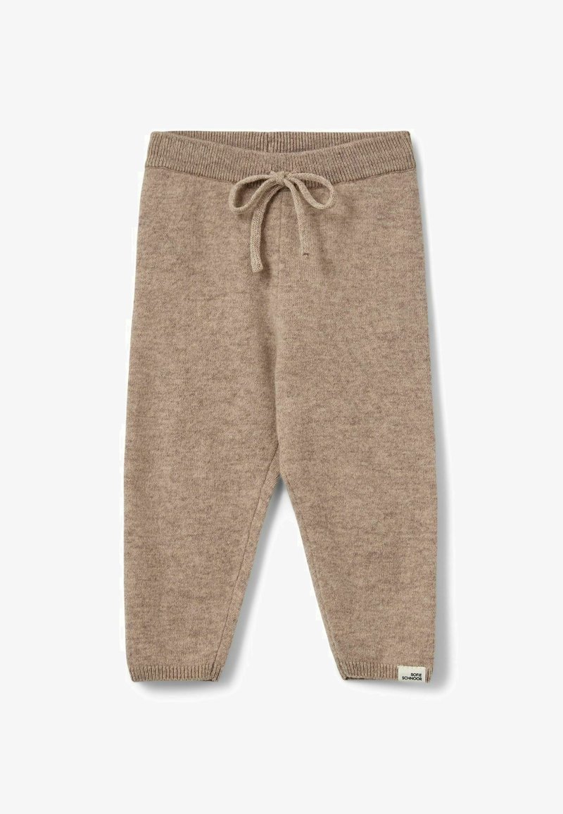 Pantalon en maille beige avec taille et poignets côtelés, doté d'un cordon noué et d'une petite étiquette en bas de la jambe gauche.