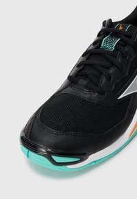 Black athletic shoe with mesh detailing, turquoise outsole, and orange accent; features a textured upper and reinforced toe cap.