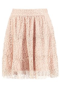 Spetskjol i ljusrosa med en utsvängd design, som har lager på lager och vågig nederkant. Tillverkad av lätt, strukturerad tyg.