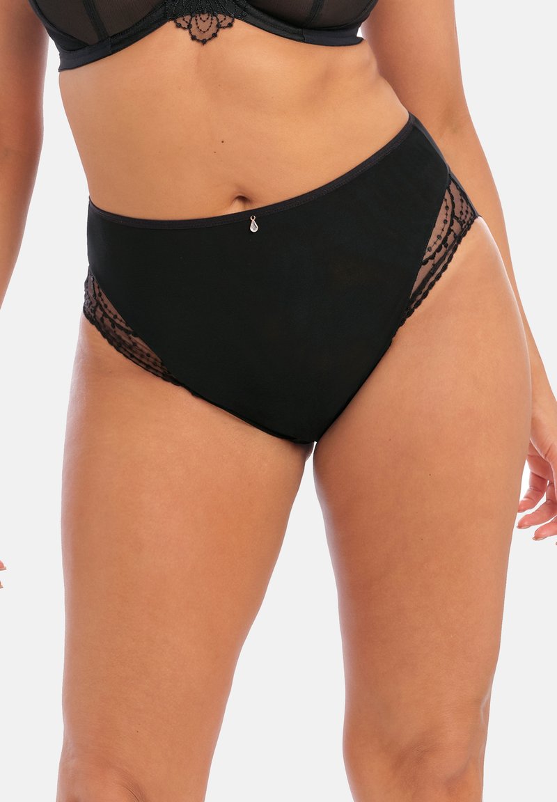 Hooggetailleerde zwarte slip met kantaccenten aan de zijkanten en een kleine decoratieve hanger aan de voorkant. Glad materiaal en klassiek design.