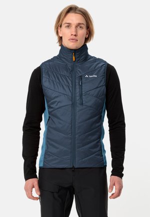 Blauwe geïsoleerde vest met verticale gestikte patroon en hoge kraag. Beschikt over een met rits gesloten voorkant en contrasterende lichtblauwe zijpanelen.