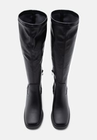 Knee-high black boots made of smooth synthetic material with a rounded toe, side zipper closure, and minimal stitching details.
