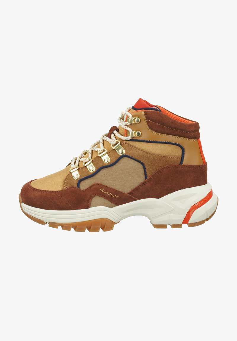 Brown and tan high-top sneaker with mixed materials, featuring metallic eyelets, orange accents, and a textured rubber sole.