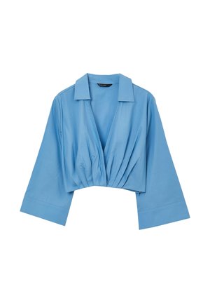 Camicetta azzurrino corta con colletto, caratterizzata da una scollatura a V e dettagli arricciati sul davanti. Realizzata in tessuto morbido con maniche ampie.