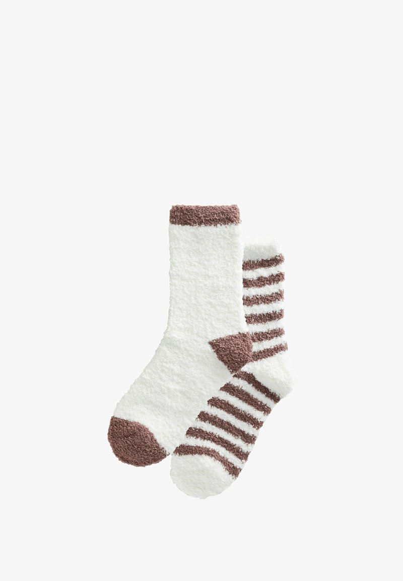 Pair of fluffy white socks; one solid with brown toe and cuff, the other white with brown stripes, heel, and toe.