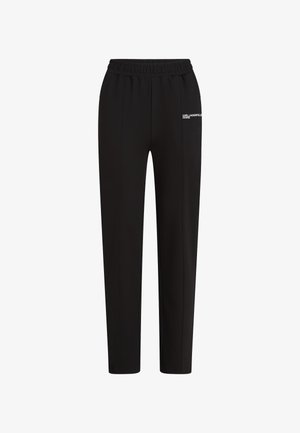 Mustad elastsedega püksid sirgete jalgadega ja valge "Karl Lagerfeld Jeans" logo vasakul reie ülaosas.