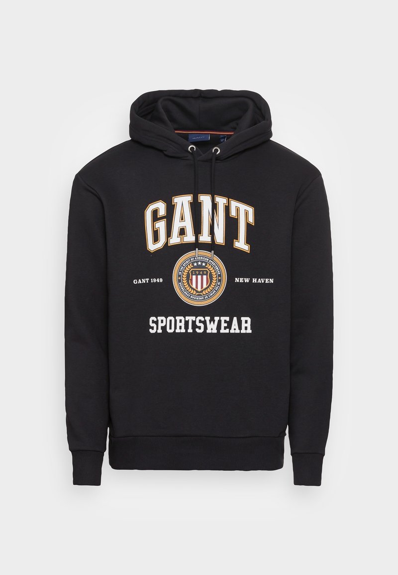 Sudadera con capucha negra con el logo "GANT", un emblema y el texto "Sportswear" en la parte frontal, que cuenta con capucha ajustable y puños y dobladillo acanalados.
