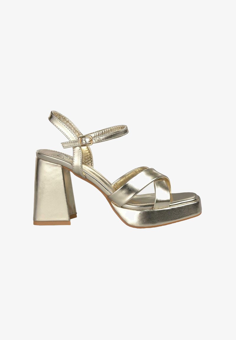 Sandali platform metallici dorati con tacco a blocco, caratterizzati da cinturini incrociati e una fibbia regolabile alla caviglia. Texture liscia.