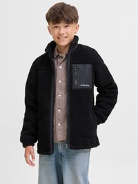 Black fleece jacket with a zippered chest pocket, featuring a contrasting smooth fabric accent. The design includes side pockets and a high collar.