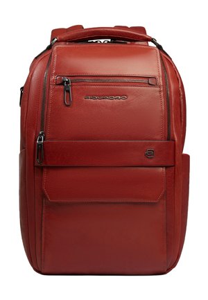 Red leather backpack with multiple zippered compartments, a front flap pocket, padded top handle, and metal brand logo "Piquadro" on front.