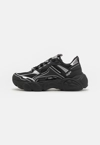 Black athletic sneakers with mesh and textile upper, reflective silver accents, thick rubber sole, and prominent cushioning detail.