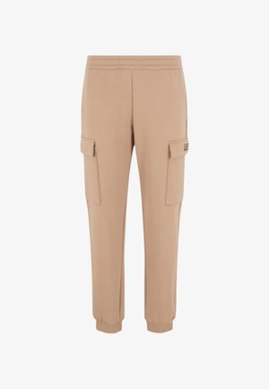 Pantalons cargo beiges en tissu doux, dotés de poches cargo latérales, de poignets élastiques et d'une taille ajustée. Design minimaliste avec des lignes épurées.