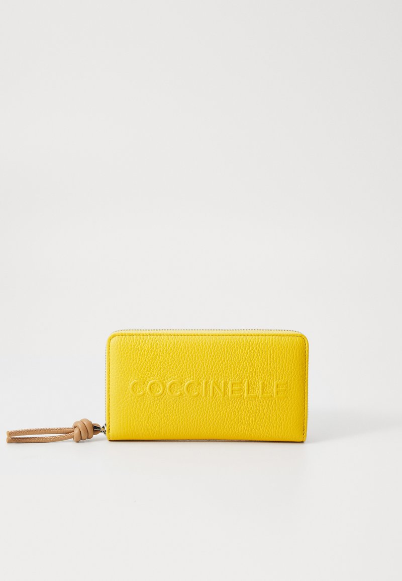 Yellow leather wallet with textured finish. Features embossed logo, zipper closure, and a tan leather wrist strap. Rectangular shape.
