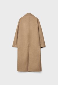 Long, brown coat made of textured fabric, featuring a notched collar and wide sleeves. The back has a central seam and no fasteners.
