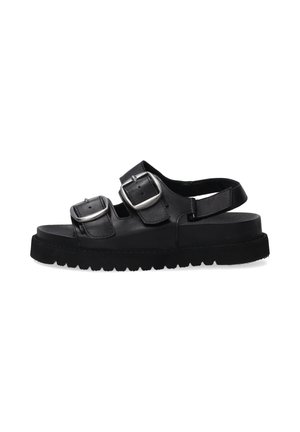 Black leather sandals feature two adjustable silver buckles, a textured sole, and a flat, platform design with a back strap for support.