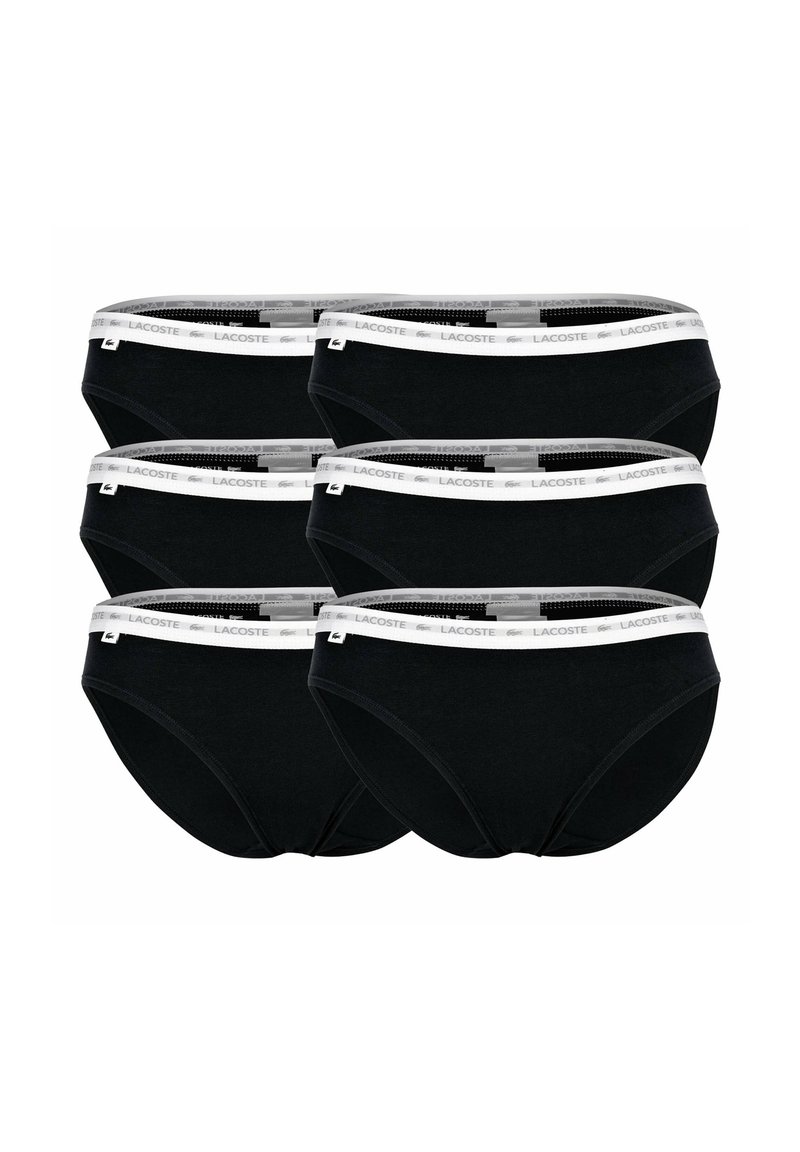 Slip in cotone neri con una vita elastica bianca che presenta il logo Lacoste. Sei paia esposte in una pila.