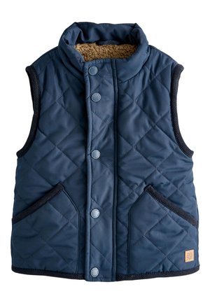 Marineblå quiltet ærmeløs vest med trykknapper, to forlommer, sort kant og brun fleeceforing i kraven.