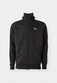 Sort zip-jakke lavet af glat stof, med hvide sidestriber og høj krave, samt et lille hvidt Puma-logo på brystet.