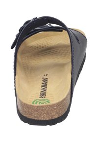 Navy blue slip-on sandal with a textured footbed, cork midsole, and rubber outsole. Features adjustable straps for fit.