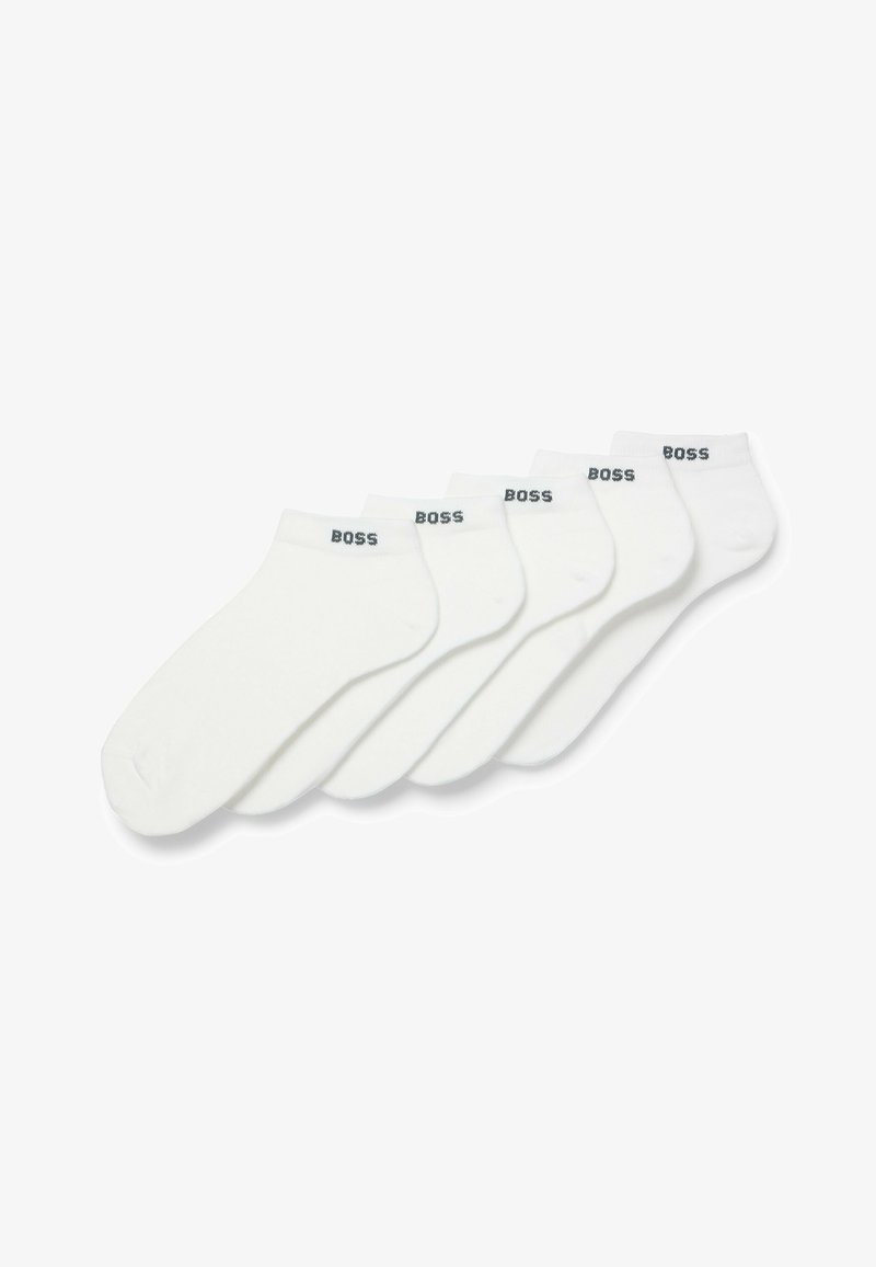 Five pairs of white ankle socks made of cotton blend, featuring a plain design with a black "BOSS" logo on the cuffs.
