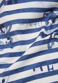 Cotton fabric with white and blue striped pattern, featuring floral graphics and text, showing soft texture and slight shine.