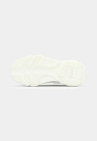 White sneaker sole with textured rubber, featuring a wavy tread pattern and a circular logo. Rounded shape enhances grip and support.