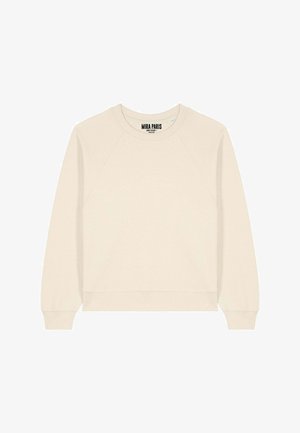 Kremowa bluza z raglanowymi rękawami, miękką fakturą i prążkowanymi ściągaczami, zestawiona z niebieskimi jeansami z wysokim stanem. Prosty wzór.