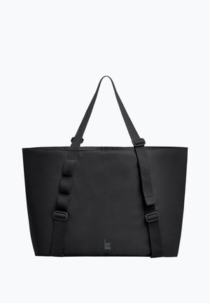 Sac fourre-tout rectangulaire noir avec deux longues bandoulières réglables et le petit texte « GOT BAG » au centre avant.