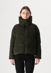 Jachetă puf cu textură de catifea închisă verde, cu guler înalt, închidere cu fermoar și model matlasat. Are mâneci largi și o siluetă scurtă.