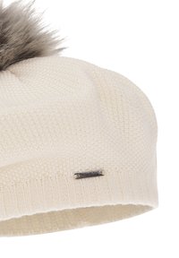 Cream-colored knit hat with a textured pattern, featuring a fluffy gray faux fur pom-pom on top and a small metal logo accent on the side.