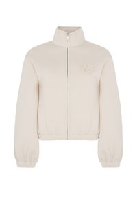 Beige zip-jakke med høj krave, der har elastiske manchetter og talje, samt et broderet "WB" logo på brystet. Glat tekstur.
