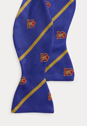 Μπλε παπιγιόν με αυτοδέσιμο, με διαγώνιες χρυσές ρίγες και μοτίβα ερυθρών, κίτρινων και μπλε εμβλημάτων σε επαναλαμβανόμενη διάταξη στο ύφασμα.