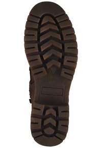 Semelle de botte en caoutchouc marron avec un motif de profondeur, présentant un bout arrondi et un logo de marque gravé. Surface texturée pour une meilleure adhérence et durabilité.