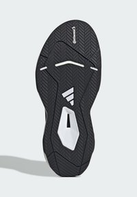 Sole di scarpa sportiva nera con motivo a spina di pesce, con accenti bianchi e un'area vuota al centro per migliorare la trazione.