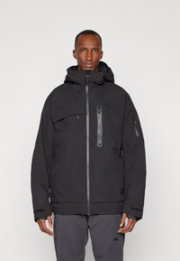 Black waterproof jacket with a hood, front zip closure, multiple zippered pockets, and textured fabric. Features adjustable cuffs and hem.