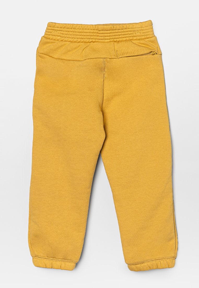 Pantalons de survêtement en coton jaune avec une taille élastique côtelée et des poignets fuselés. Texture lisse, sans poches ni embellissements.