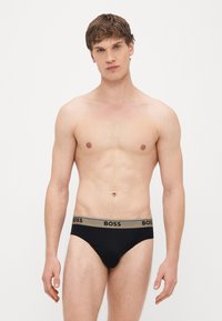 Vyriškos juodos trumpikės su minkštu juosmeniu, ant kurio užrašyta „BOSS“. Pagamintos iš tamprios medžiagos, skirtos patogumui ir geram prigludimui.