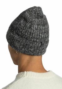 Gray knitted beanie with a textured finish, featuring a rolled cuff and a small black logo tag on the back.