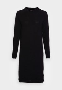Svart ribbad klänning med hög hals, långa ärmar, figurnära design och texturerat mönster, som når till midjan. Inga synliga knäppningar.